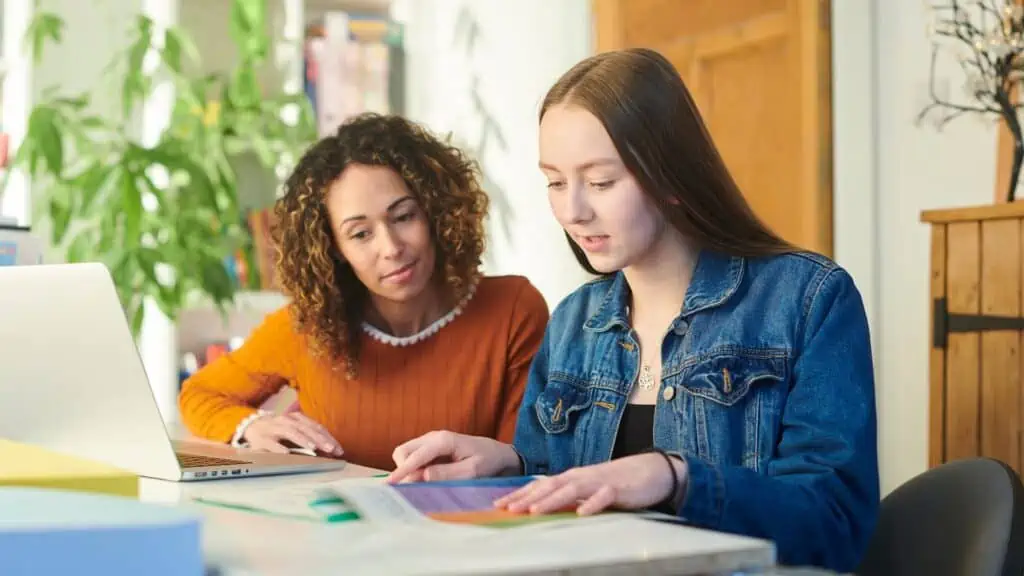 Teacher assisting student with poor grades, offering guidance and support.
